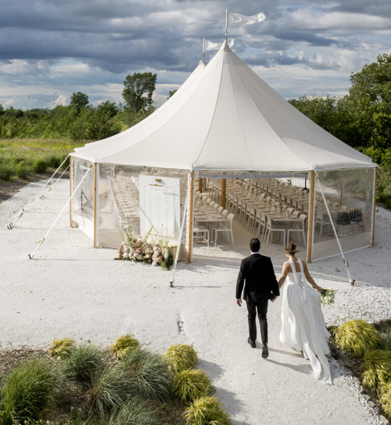Couple enters reception tent at The Brighthouse Farm, Prince Edward County
